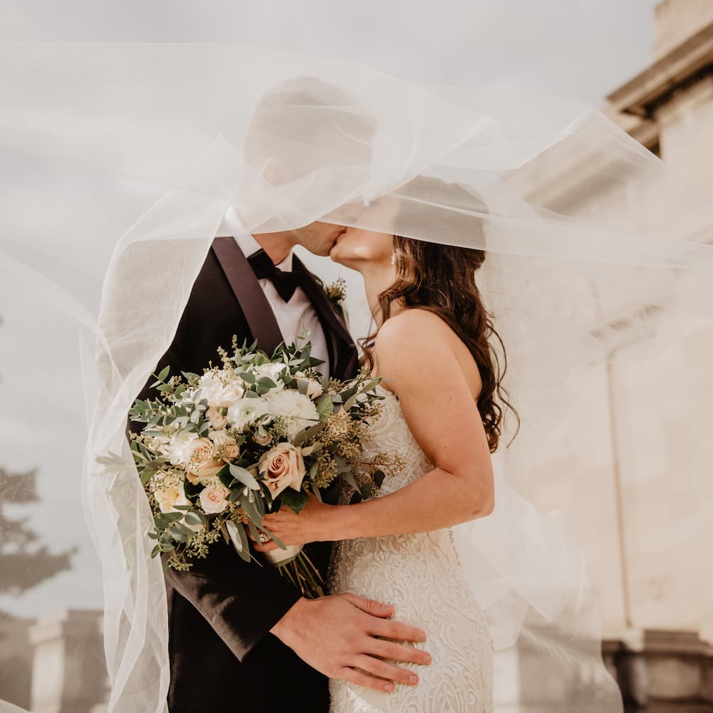 A picture of a couple on their wedding kissing