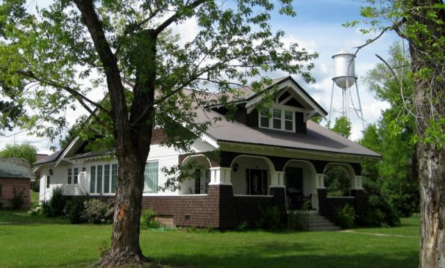 The Cambridge outside with a water tower in the distance